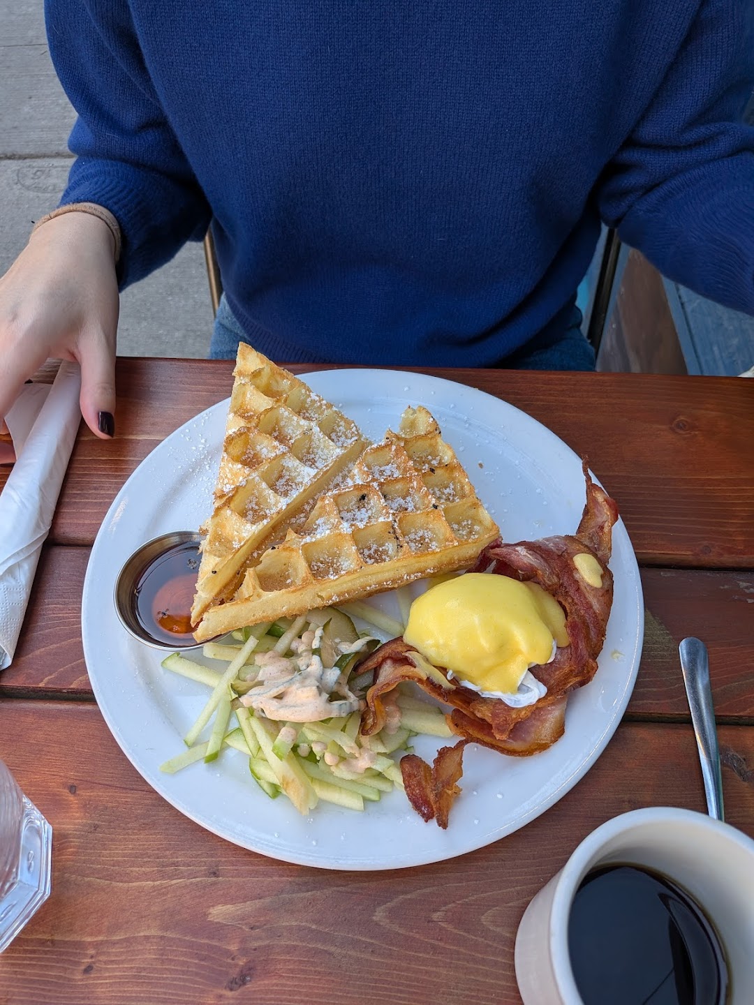 Patio brunch with waffles, eggs Benedict, bacon and coffee