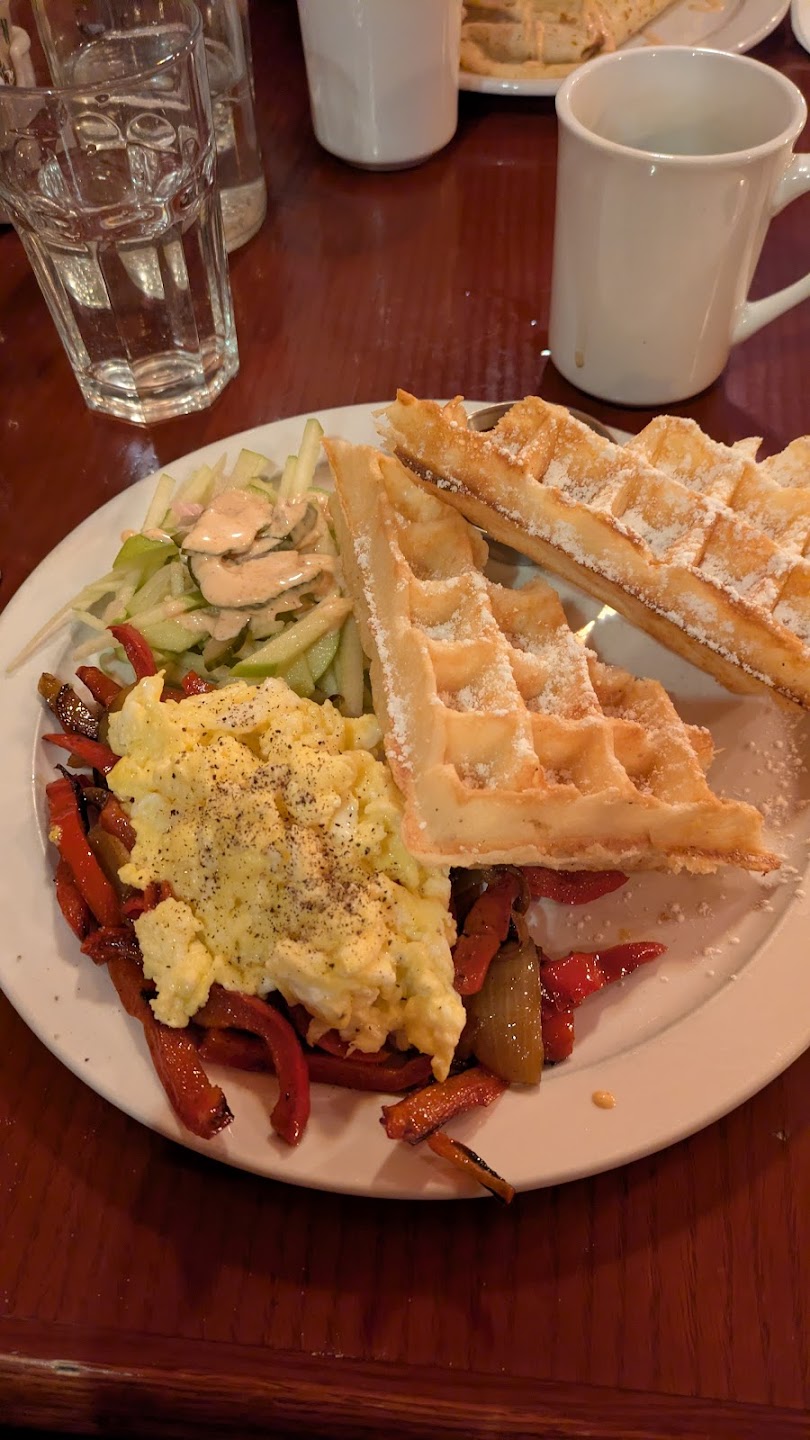 Belgian waffle plate with scrambled eggs and peppers
