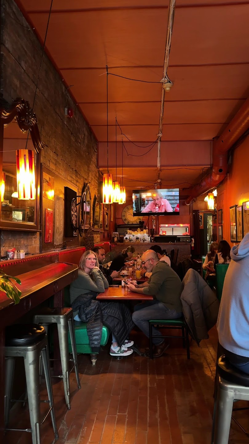 Warm dining room interior at Petit Dejeuner with seated customers enjoying brunch